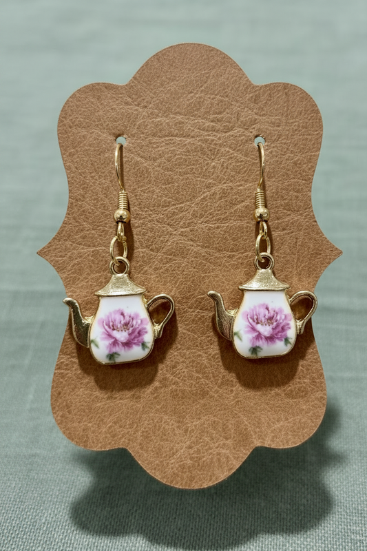Teapot-shaped earrings with floral design on a brown background